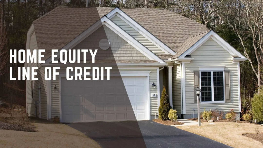 Bank Local. Home Equity Line of Credit. Tan house sitting on a wooded lot with a paved driveway. 
