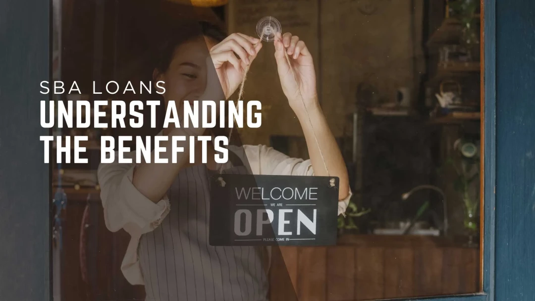 Bank Local. SBA Loans understanding the benefits. A women putting up a welcome open sign.